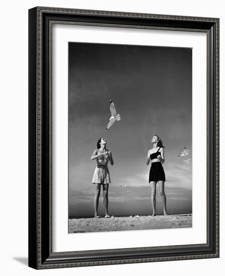 Models Tee Matthews and Bobbie Chambliss Feeding Gulls While Modeling New Bathing Suit Styles-Alfred Eisenstaedt-Framed Photographic Print