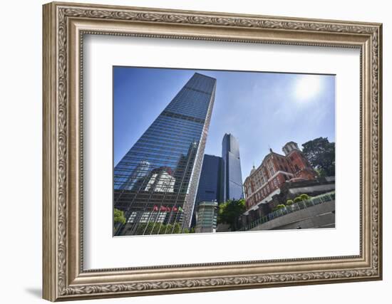 Modern skyscrapers stand next to the colonial Former French Mission Building in Central, Hong Kong-Fraser Hall-Framed Photographic Print