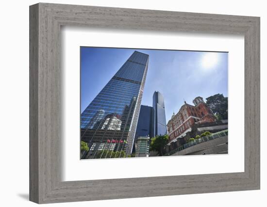 Modern skyscrapers stand next to the colonial Former French Mission Building in Central, Hong Kong-Fraser Hall-Framed Photographic Print