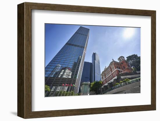 Modern skyscrapers stand next to the colonial Former French Mission Building in Central, Hong Kong-Fraser Hall-Framed Photographic Print