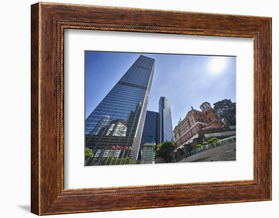 Modern skyscrapers stand next to the colonial Former French Mission Building in Central, Hong Kong-Fraser Hall-Framed Photographic Print