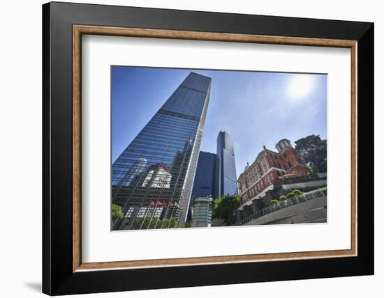 Modern skyscrapers stand next to the colonial Former French Mission Building in Central, Hong Kong-Fraser Hall-Framed Photographic Print