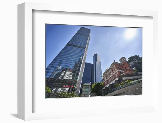 Modern skyscrapers stand next to the colonial Former French Mission Building in Central, Hong Kong-Fraser Hall-Framed Photographic Print