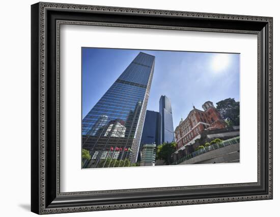 Modern skyscrapers stand next to the colonial Former French Mission Building in Central, Hong Kong-Fraser Hall-Framed Photographic Print