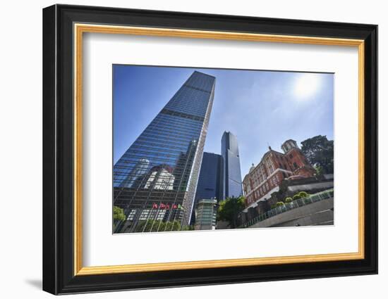 Modern skyscrapers stand next to the colonial Former French Mission Building in Central, Hong Kong-Fraser Hall-Framed Photographic Print