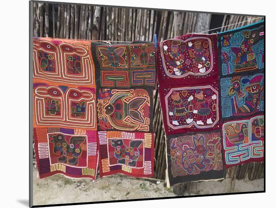 Molas Hanging Up for Sale Outside Thatched House, Isla Tigre, San Blas Islands, Panama-Jane Sweeney-Mounted Photographic Print