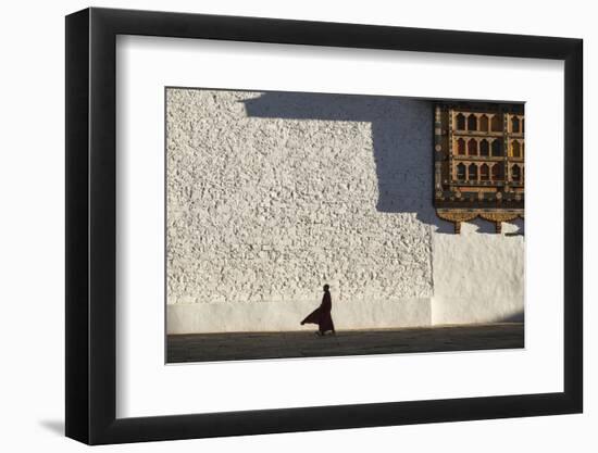 Monk walks through the courtyard of Rinpung Dzong Monastery, Bhutan.-Brenda Tharp-Framed Photographic Print