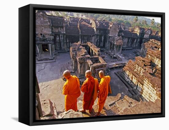 Monks Overlook Angkor Wat, Cambodia-Tom Haseltine-Framed Premier Image Canvas