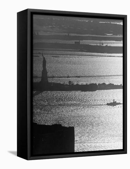 Moonlight on the Waters Surrounding Statue of Liberty as a Tug Boat Steams Past in New York Harbor-Andreas Feininger-Framed Premier Image Canvas