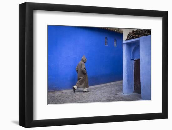 Morocco. A man walks through an alley in the blue-washed city of Chefchaouen.-Brenda Tharp-Framed Photographic Print