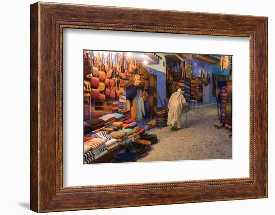 Morocco. An elderly man walks past tourist shops along a street in the blue city of Chefchaouen.-Brenda Tharp-Framed Photographic Print