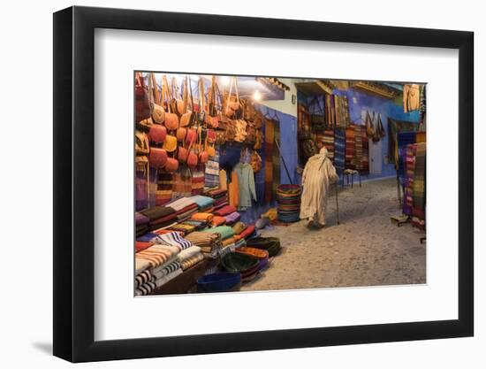 Morocco. An elderly man walks past tourist shops along a street in the blue city of Chefchaouen.-Brenda Tharp-Framed Photographic Print