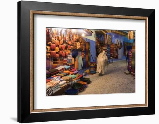 Morocco. An elderly man walks past tourist shops along a street in the blue city of Chefchaouen.-Brenda Tharp-Framed Photographic Print