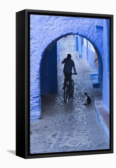 Morocco, Chefchaouen. Bicyclist Rides Past Cat in Archway in the Blue Village of Chefchaouen-Brenda Tharp-Framed Premier Image Canvas
