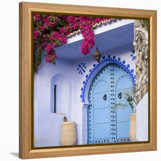 Morocco, Chefchaouen. Bougainvillea Blossoms Frame an Ornate Blue Door-Brenda Tharp-Framed Premier Image Canvas