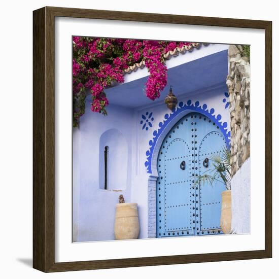 Morocco, Chefchaouen. Bougainvillea Blossoms Frame an Ornate Blue Door-Brenda Tharp-Framed Photographic Print