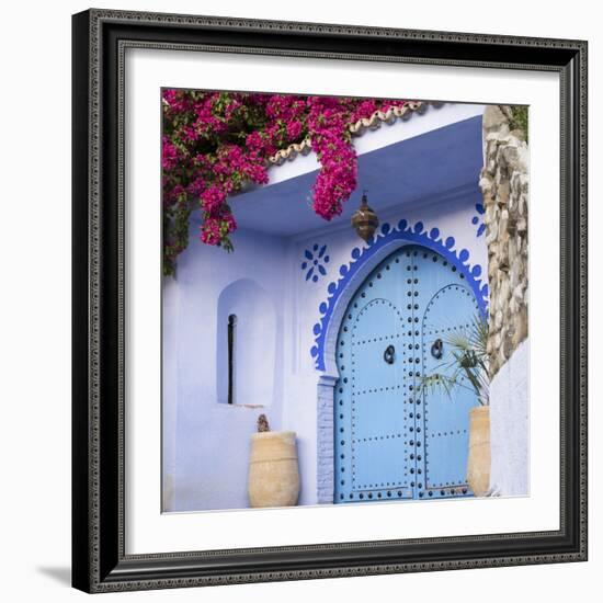 Morocco, Chefchaouen. Bougainvillea Blossoms Frame an Ornate Blue Door-Brenda Tharp-Framed Photographic Print