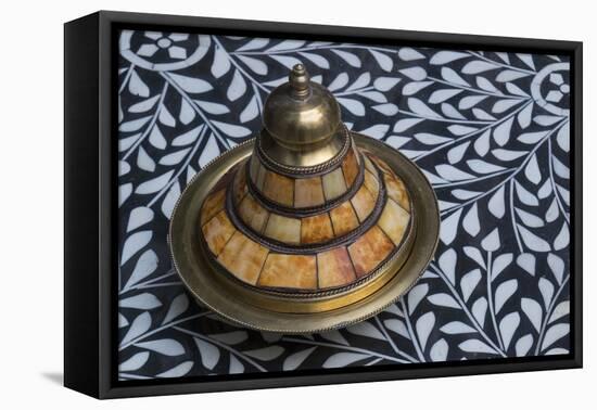 Morocco, Fes. A covered brass bowl with inlay of camel bone sites on a stone inlay table in a shop.-Brenda Tharp-Framed Premier Image Canvas