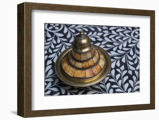 Morocco, Fes. A covered brass bowl with inlay of camel bone sites on a stone inlay table in a shop.-Brenda Tharp-Framed Photographic Print