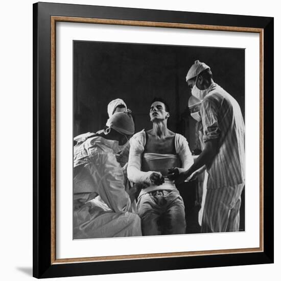 Mortar Wounded Army Medic Private George Lott, Sitting Up While 4 Army Surgeons Finish Up His Cast-Ralph Morse-Framed Photographic Print