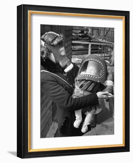 Mother and Baby Wearing Gas Masks During Gas Preparations Test During WWII-Hans Wild-Framed Photographic Print