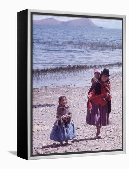 Mother and Two Children Holding Ball of Yarn, Andean Highlands of Bolivia-Bill Ray-Framed Premier Image Canvas