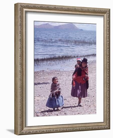 Mother and Two Children Holding Ball of Yarn, Andean Highlands of Bolivia-Bill Ray-Framed Photographic Print