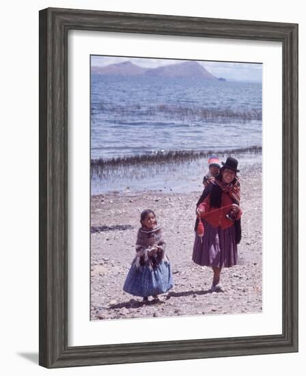 Mother and Two Children Holding Ball of Yarn, Andean Highlands of Bolivia-Bill Ray-Framed Photographic Print