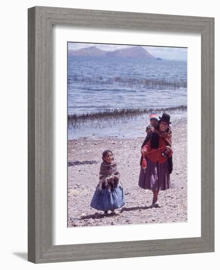 Mother and Two Children Holding Ball of Yarn, Andean Highlands of Bolivia-Bill Ray-Framed Photographic Print