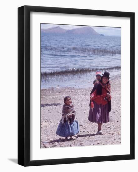 Mother and Two Children Holding Ball of Yarn, Andean Highlands of Bolivia-Bill Ray-Framed Photographic Print