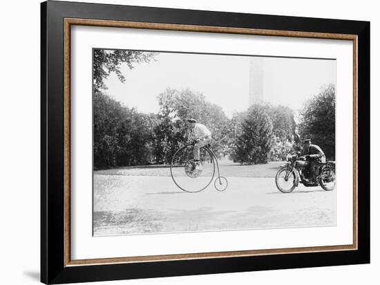 Motorcycle Cop Chases a Penny Farthing Velocipede Down a DC Street with Washington Monument in Back-null-Framed Art Print