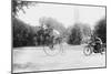 Motorcycle Cop Chases a Penny Farthing Velocipede Down a DC Street with Washington Monument in Back-null-Mounted Art Print