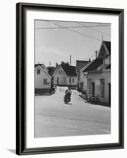 Motorcycle Going Down Street in Small Town-null-Framed Photographic Print