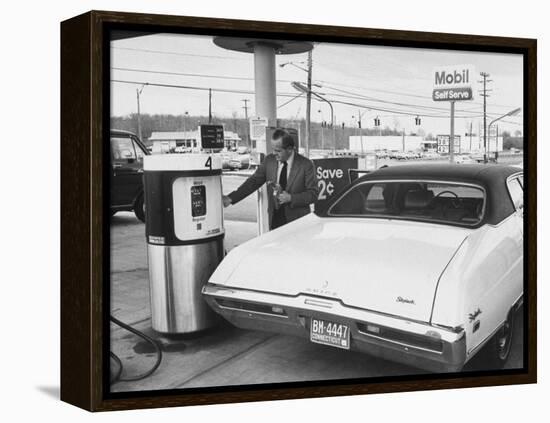 Motorist Filling Up His Own Car at a Self Service Gas Station-Ralph Morse-Framed Premier Image Canvas