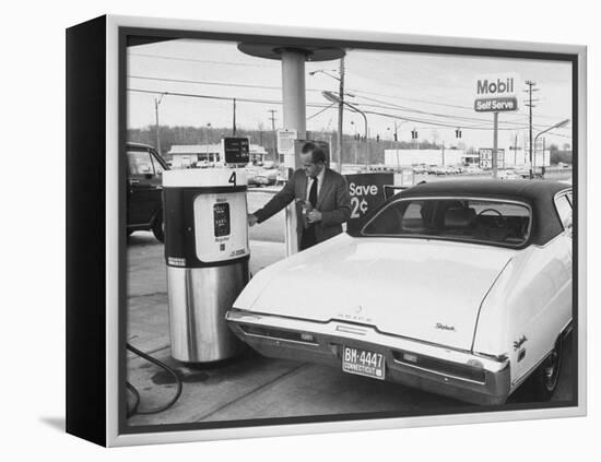 Motorist Filling Up His Own Car at a Self Service Gas Station-Ralph Morse-Framed Premier Image Canvas