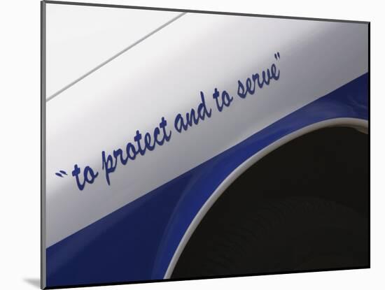 Motto on Police Car-null-Mounted Photographic Print