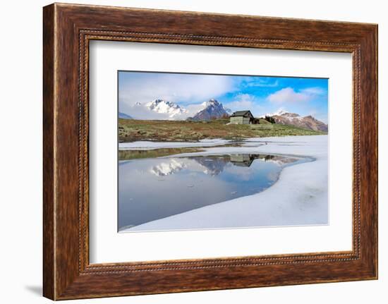 Mountain hut on shore of frozen pond during thaw, Scermendone Alp, Rhaetian Alps, Valtellina-Roberto Moiola-Framed Photographic Print