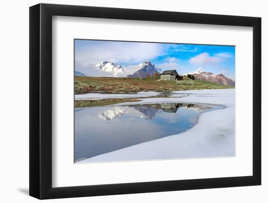 Mountain hut on shore of frozen pond during thaw, Scermendone Alp, Rhaetian Alps, Valtellina-Roberto Moiola-Framed Photographic Print