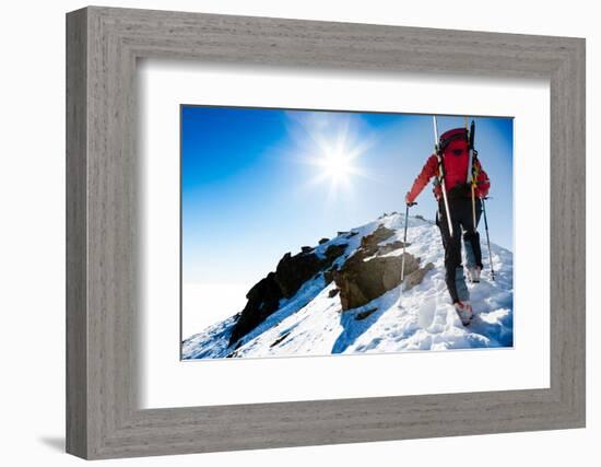 Mountaineer Walking up along a Snowy Ridge with the Skis in the Backpack. in Background a Shiny Bri-Roberto Caucino-Framed Photographic Print