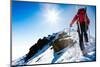 Mountaineer Walking up along a Snowy Ridge with the Skis in the Backpack. in Background a Shiny Bri-Roberto Caucino-Mounted Photographic Print