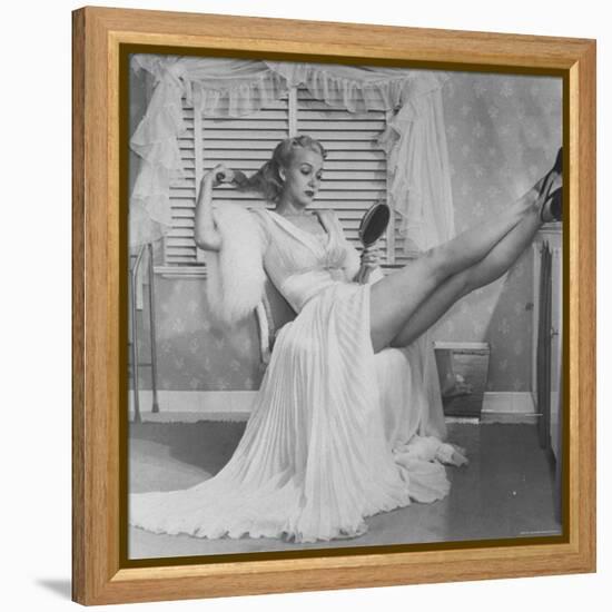 Movie Actress Carole Landis in Negligee as she Brushes Her Hair, Showing Off Gorgeous Legs-Peter Stackpole-Framed Premier Image Canvas