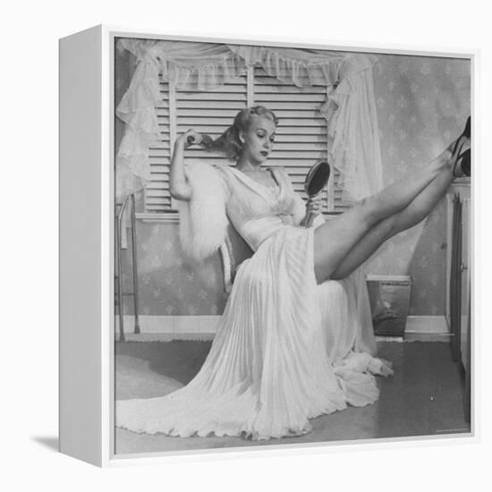 Movie Actress Carole Landis in Negligee as she Brushes Her Hair, Showing Off Gorgeous Legs-Peter Stackpole-Framed Premier Image Canvas