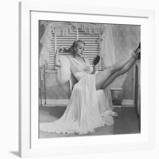 Movie Actress Carole Landis in Negligee as she Brushes Her Hair, Showing Off Gorgeous Legs-Peter Stackpole-Framed Premium Photographic Print