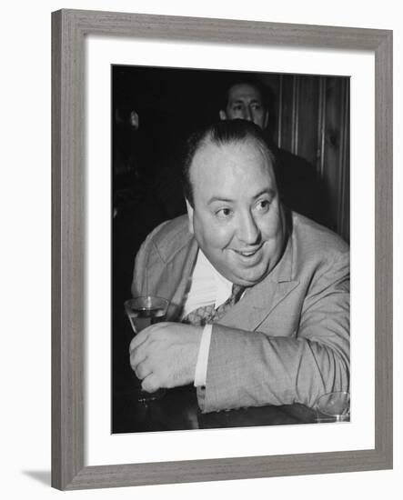 Movie Director Alfred Hitchcock Sits at Chasen's Bar While Enjoying a Cocktail Hour-Peter Stackpole-Framed Premium Photographic Print