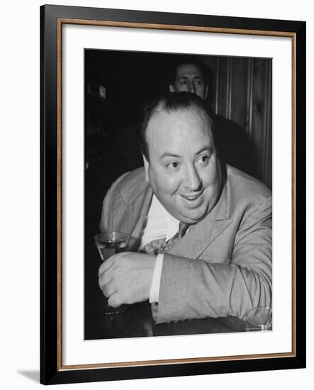 Movie Director Alfred Hitchcock Sits at Chasen's Bar While Enjoying a Cocktail Hour-Peter Stackpole-Framed Premium Photographic Print