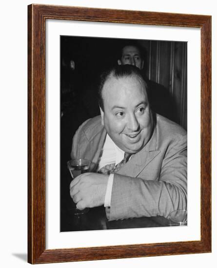 Movie Director Alfred Hitchcock Sits at Chasen's Bar While Enjoying a Cocktail Hour-Peter Stackpole-Framed Premium Photographic Print