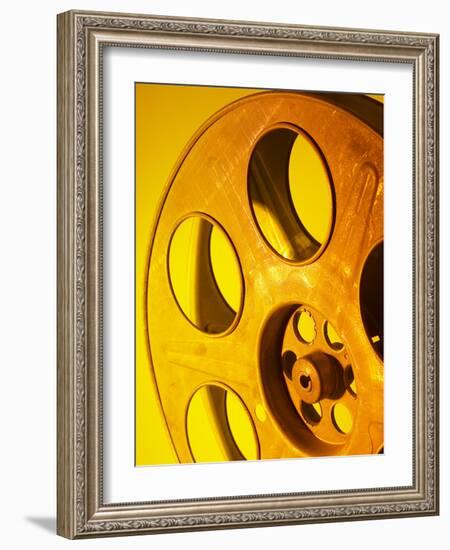 Movie Film and Reels in Yellow Light-null-Framed Photographic Print