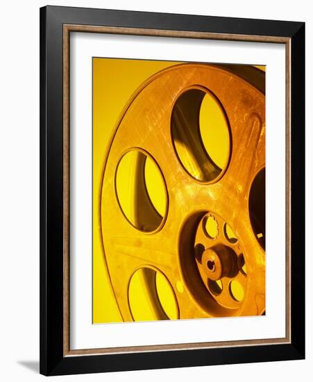 Movie Film and Reels in Yellow Light-null-Framed Photographic Print