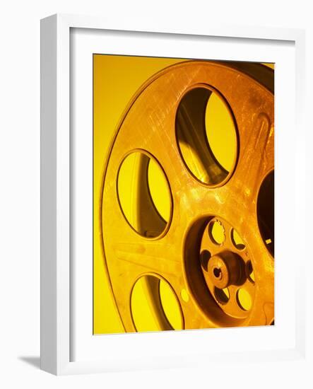 Movie Film and Reels in Yellow Light-null-Framed Photographic Print