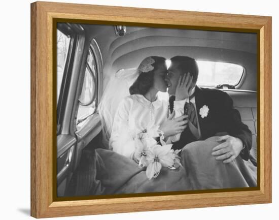 Mr. and Mrs. Thomas Beagan Jr. Kissing in Back of Car after their Wedding Ceremony-Ed Clark-Framed Premier Image Canvas